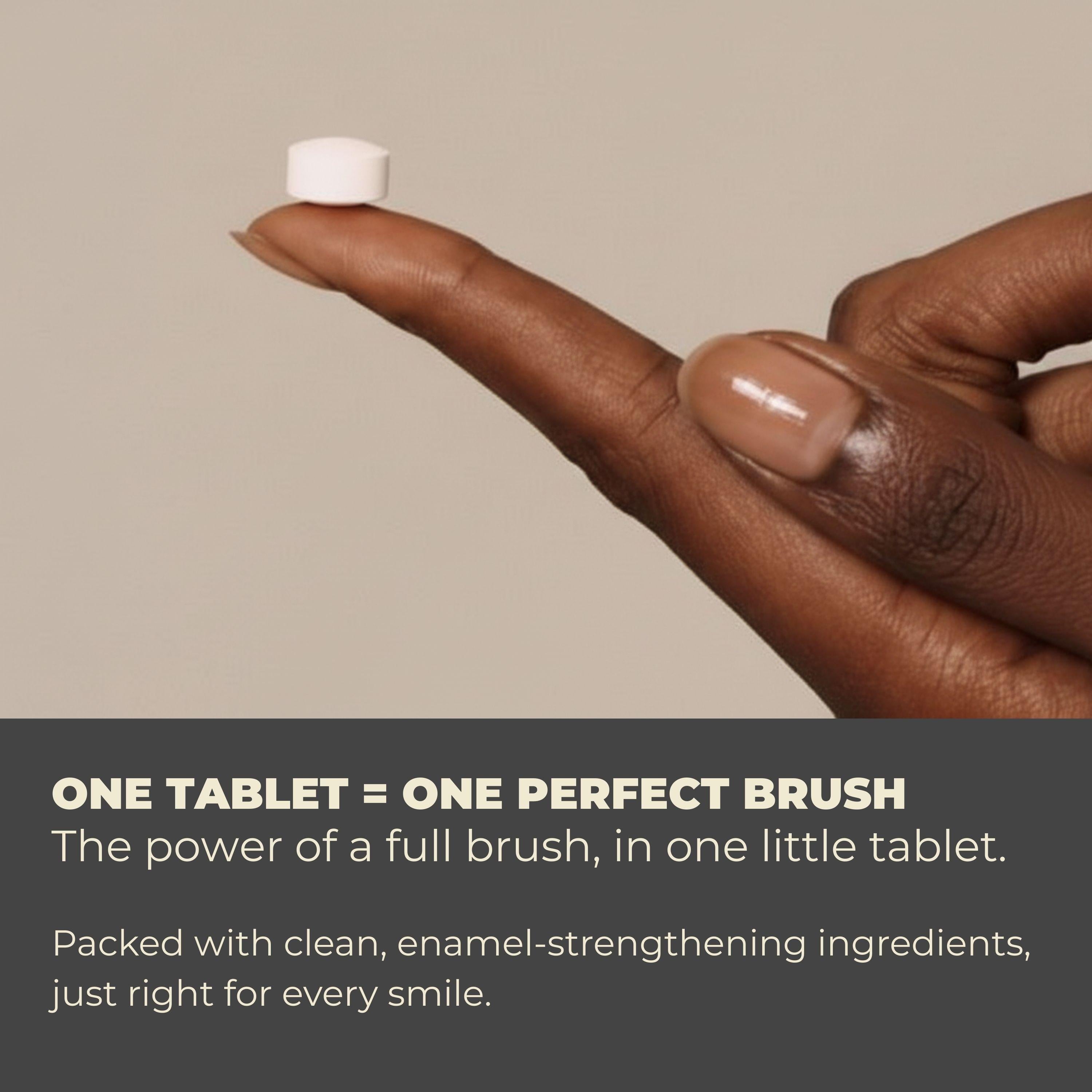 Hand holding a small white tablet with promotional text about its dental benefits on a beige background