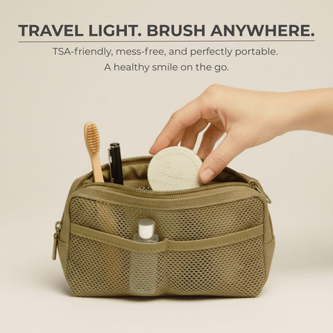 Travel-sized dental care kit with toothbrush, toothpaste, and other items in a beige pouch on a light background.
