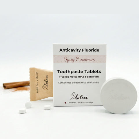 Tidalove Anticavity Fluoride Toothpaste Tablets packaging with tablets and a cinnamon stick on a white background