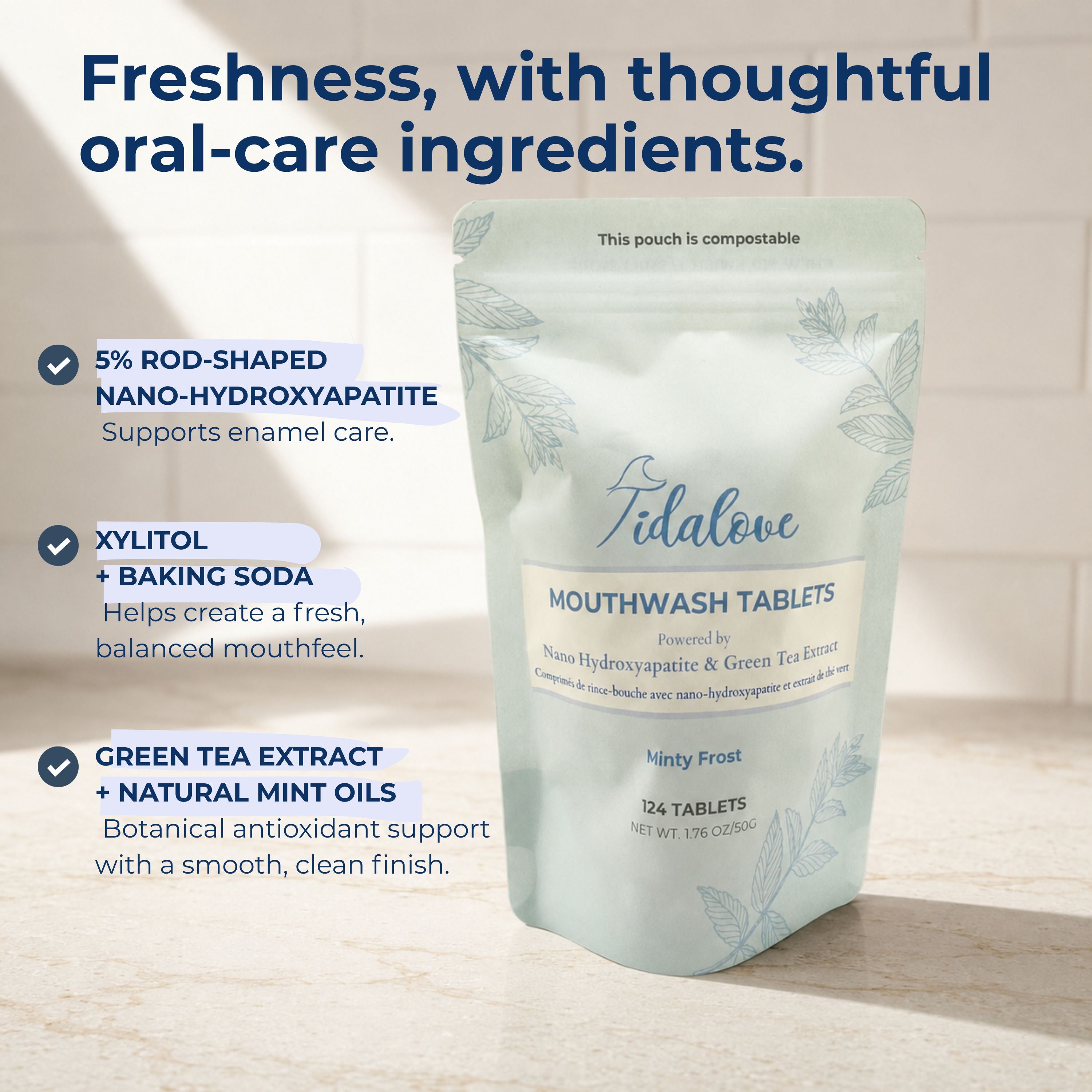 A stand-up pouch of Tidalove Mouthwash Tablets on a light stone surface with marketing text callouts on the left. The pouch is pale mint green with white and blue-gray text and leaf illustrations.