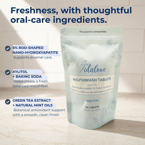 A stand-up pouch of Tidalove Mouthwash Tablets on a light stone surface with marketing text callouts on the left. The pouch is pale mint green with white and blue-gray text and leaf illustrations.
