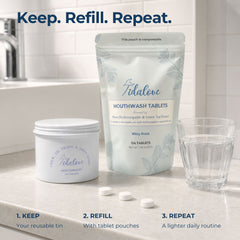 Tidalove Mouthwash Tablets set on a kitchen counter with a glass, three tablets, and a reusable tin next to a refill pouch. Text at the top reads 'Keep.